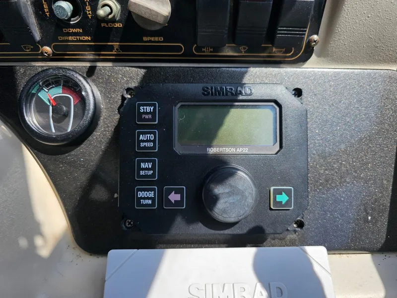 Slide: The Image of Control panel of a 2000 Cruisers 3870 Express boat with Simrad autopilot system. - 12