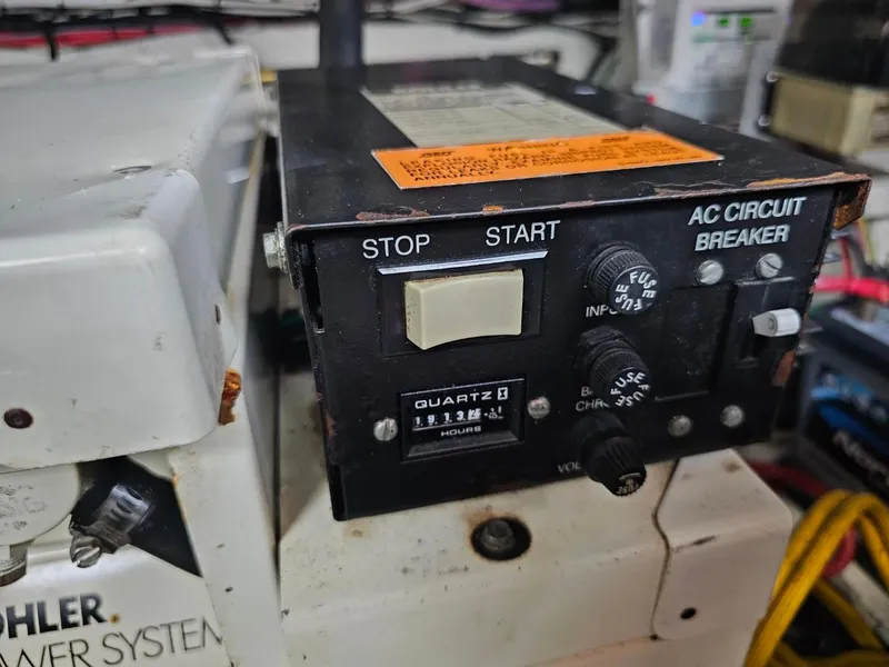 Slide: The Image of Control panel of a 2000 Cruisers 3870 Express boat with AC circuit breaker. - 18