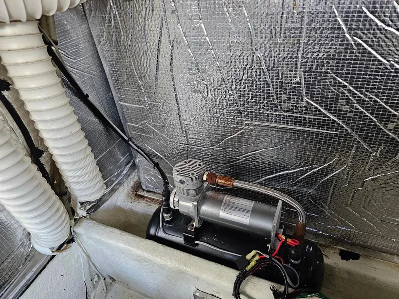 Slide: The Image of Engine compartment of 2000 Cruisers 3870 Express with visible machinery and insulation. - 19