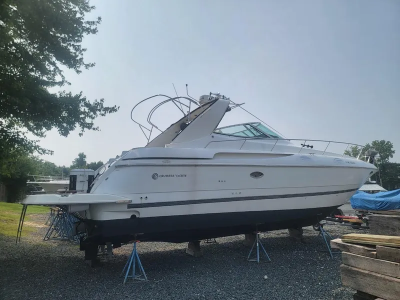 Slide: The Image of 2000 Cruisers 3870 Express yacht on stands, side view, outdoors. - 4