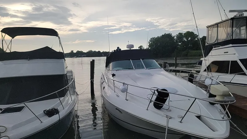 Slide: The Image of 2000 Cruisers 3870 Express yacht docked at marina during sunset. - 6