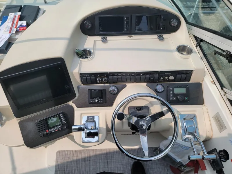 Slide: The Image of Cockpit of 2000 Cruisers 3870 Express with steering wheel and navigation controls. - 8