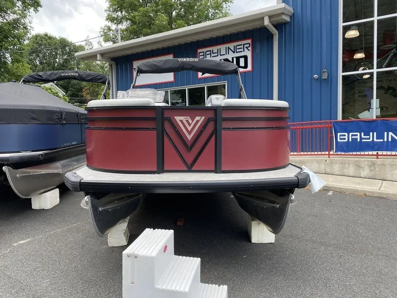Slide: The Image of 2024 Viaggio Lago V-18U Bi-Toon pontoon boat displayed at a dealership. - 3