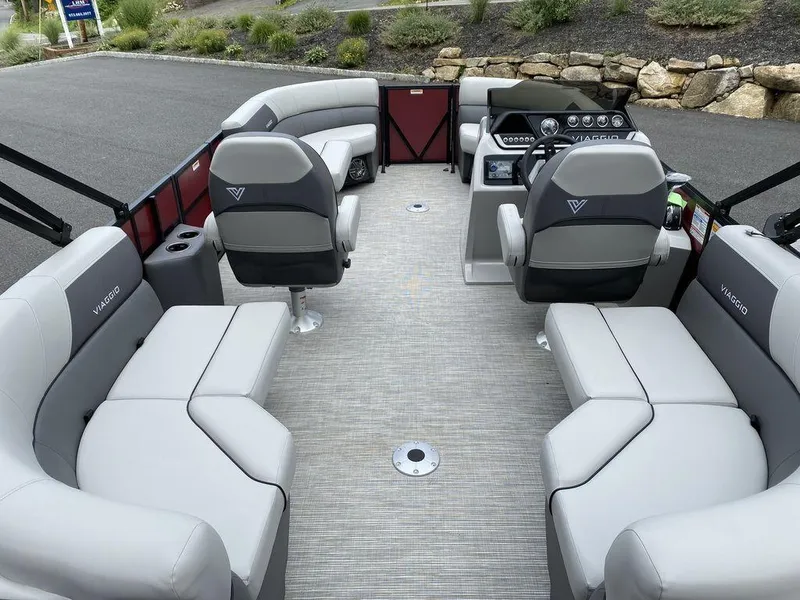 Slide: The Image of 2024 Viaggio Lago V-18U Bi-Toon pontoon boat interior with gray seating and modern dashboard. - 6