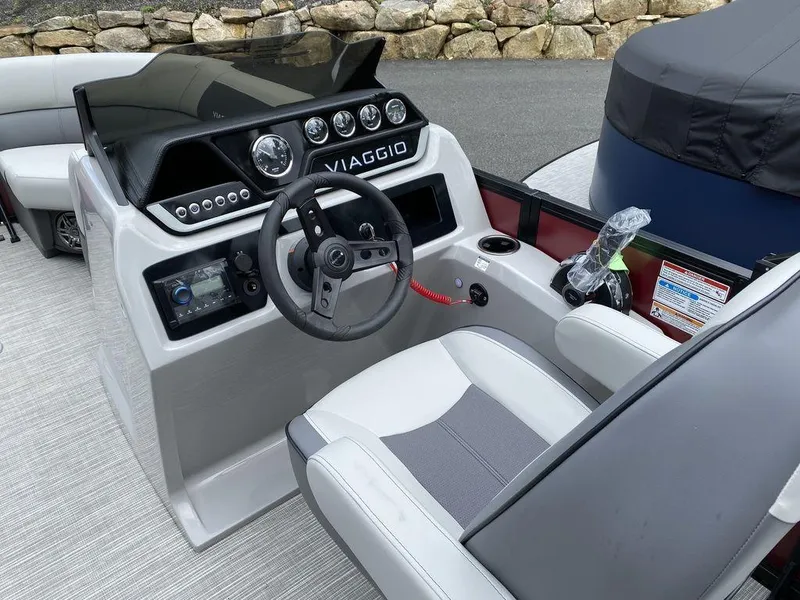 Slide: The Image of 2024 Viaggio Lago V-18U Bi-Toon boat cockpit with steering wheel and control panel. - 7