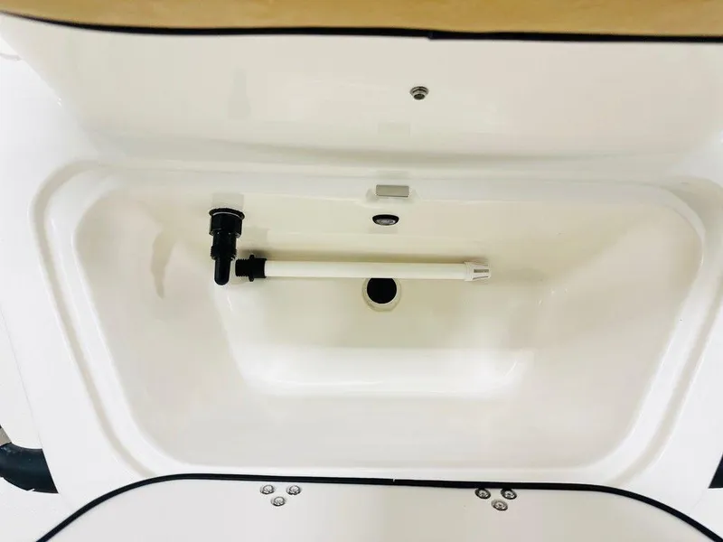 Slide: The Image of 2024 Carolina Skiff 19 LS livewell interior with plumbing components. - 3