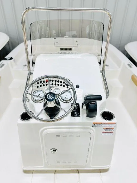 Slide: The Image of 2024 Carolina Skiff 19 LS center console with steering wheel and controls. - 5