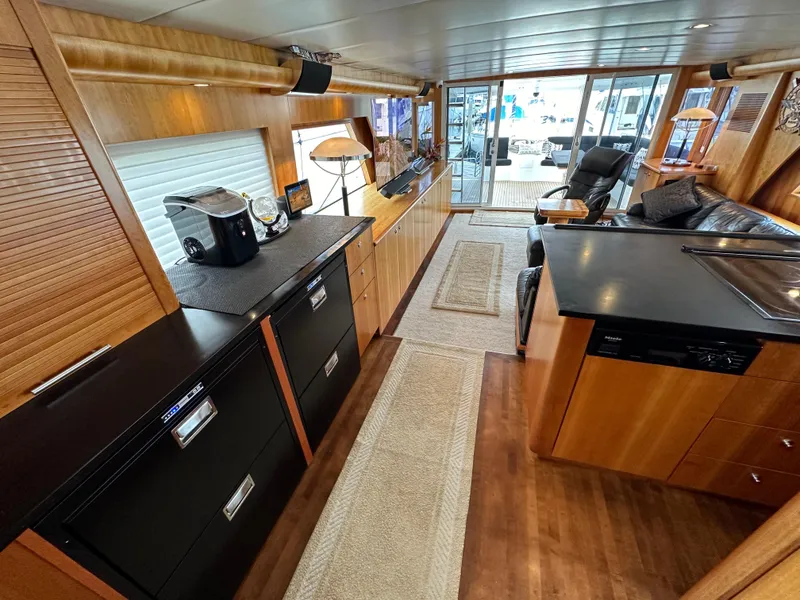 Slide: The Image of Interior of a 1999 Queenship Cockpit Motoryacht with modern kitchen and seating area. - 11
