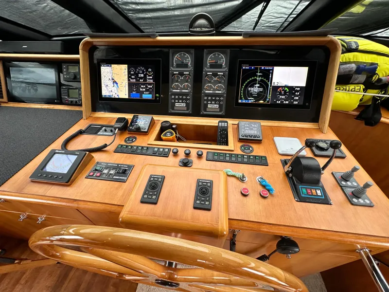 Slide: The Image of 1999 Queenship Cockpit Motoryacht helm with navigation and control instruments. - 16