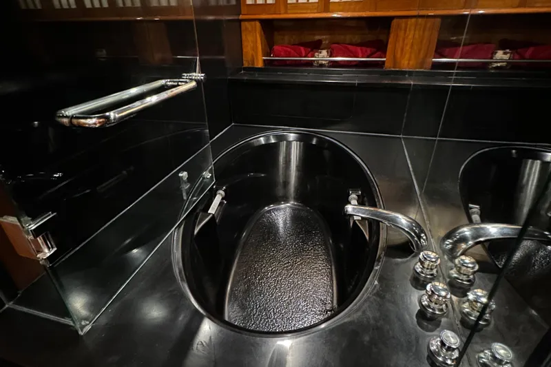 Slide: The Image of Luxurious black bathtub in 1999 Queenship Cockpit Motoryacht bathroom. - 30