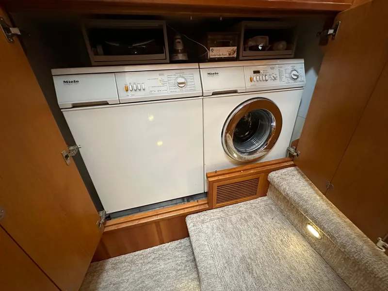Slide: The Image of Laundry area in 1999 Queenship Cockpit Motoryacht with Miele washer and dryer. - 32