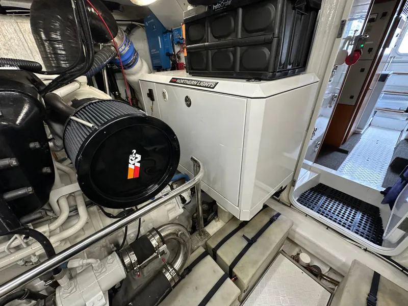 Slide: The Image of Engine room of a 1999 Queenship Cockpit Motoryacht with machinery and equipment. - 42
