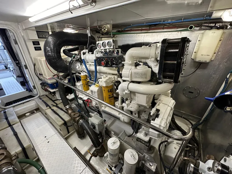Slide: The Image of Engine room of a 1999 Queenship Cockpit Motoryacht with detailed machinery. - 44