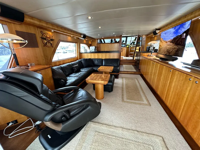 Slide: The Image of Luxurious interior of a 1999 Queenship Cockpit Motoryacht with leather seating and modern amenities. - 6
