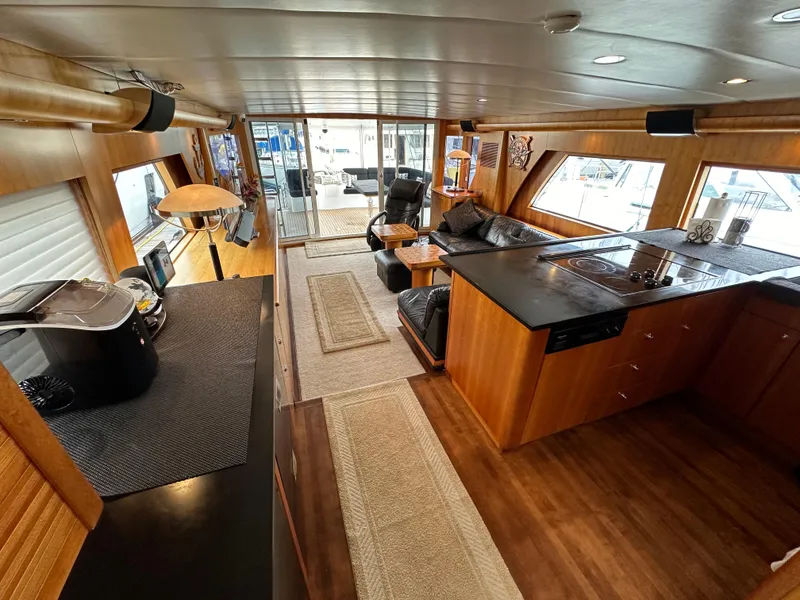 Slide: The Image of Luxurious interior of a 1999 Queenship Cockpit Motoryacht with modern kitchen and cozy seating area. - 7