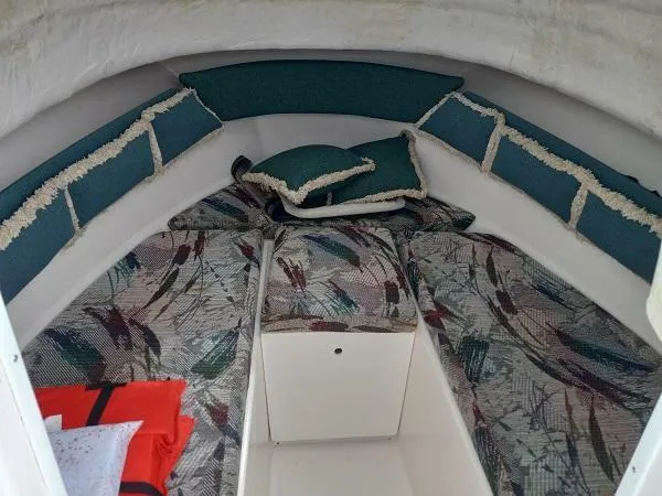 Slide: The Image of Cabin interior of 2003 Key Largo 2200 WA boat with patterned cushions and pillows. - 12
