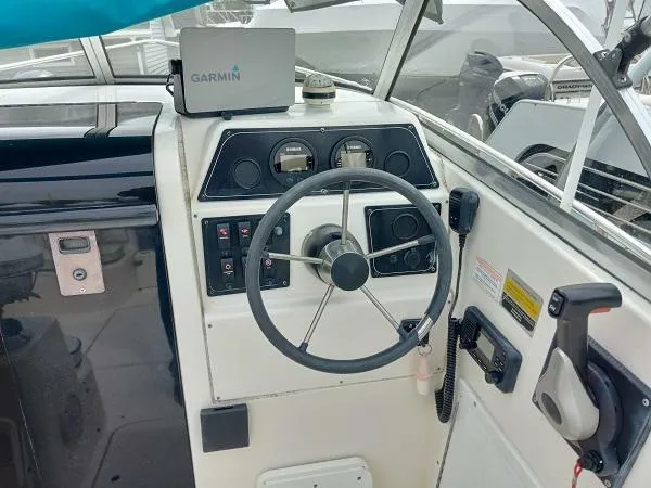 Slide: The Image of 2003 Key Largo 2200 WA boat cockpit with Garmin navigation system. - 13