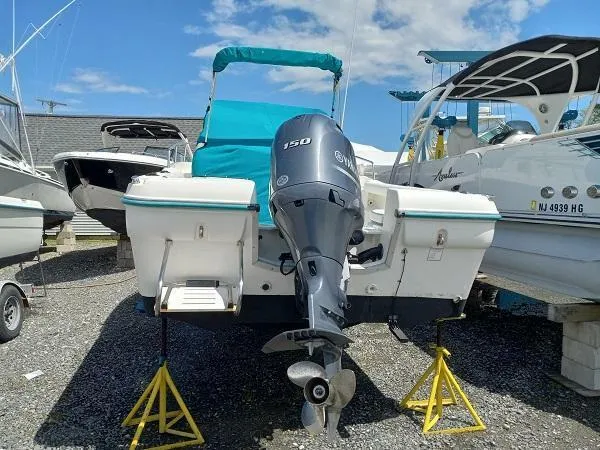 Slide: The Image of 2003 Key Largo 2200 WA boat with 150 HP engine on stands. - 4