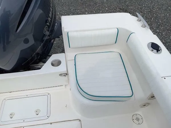 Slide: The Image of 2003 Key Largo 2200 WA boat seating area with Yamaha outboard motor. - 6