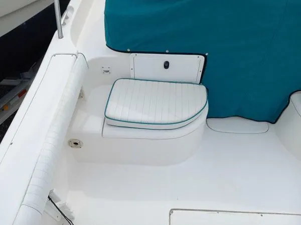 Slide: The Image of 2003 Key Largo 2200 WA boat interior with white and teal seating. - 7
