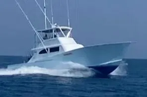 The Image of 2022 Custom Carolina Sportfish boat cruising at sunset. - 0