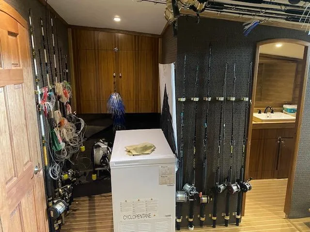 Slide: The Image of Custom Carolina Sportfish 2022 interior with fishing rods and gear storage. - 14