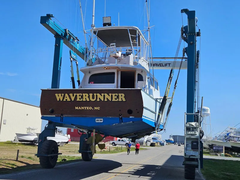 Slide: The Image of 2022 Custom Carolina Sportfish Waverunner in boat lift at marina, Manteo, NC. - 2