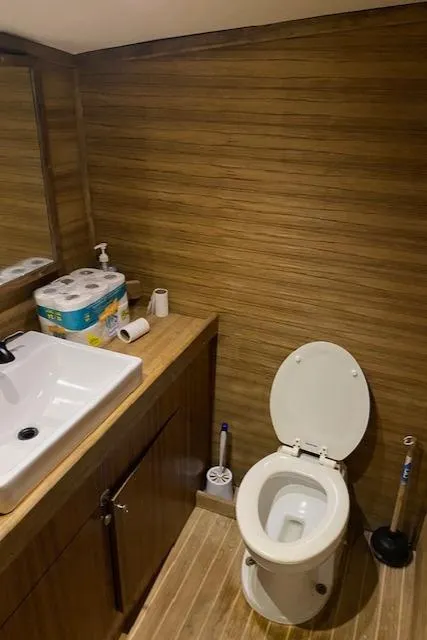 Slide: The Image of Modern bathroom in 2022 Custom Carolina Sportfish boat with wooden accents. - 20