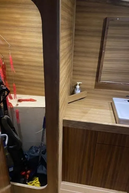 Slide: The Image of 2022 Custom Carolina Sportfish interior with wooden cabinetry and sink. - 21