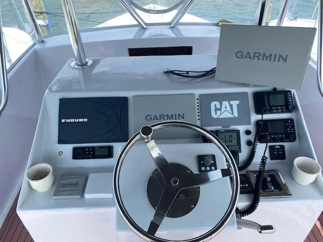 Slide: The Image of 2022 Custom Carolina Sportfish helm with Garmin, Furuno, and CAT electronics. - 29