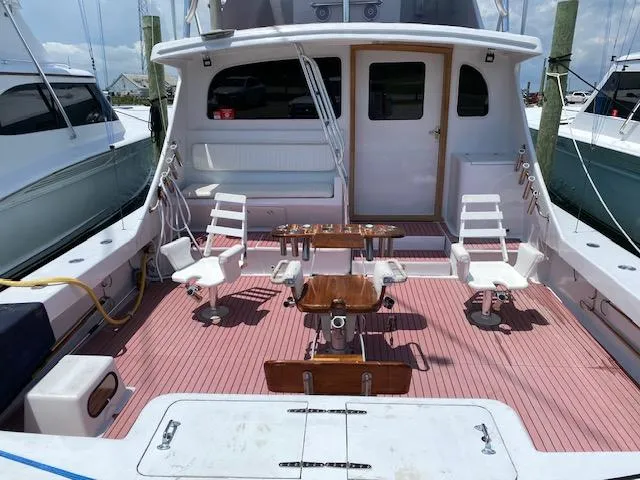 Slide: The Image of 2022 Custom Carolina Sportfish boat deck with fishing chairs and equipment. - 3