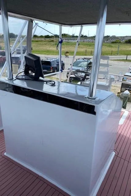 Slide: The Image of 2022 Custom Carolina Sportfish boat helm station with navigation equipment. - 33