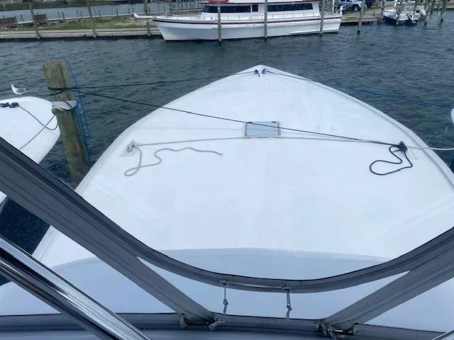 Slide: The Image of 2022 Custom Carolina Sportfish boat docked at a marina, view from the bow. - 36