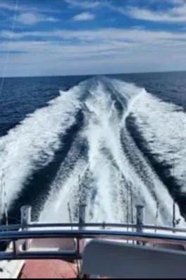 Slide: The Image of 2022 Custom Carolina Sportfish boat cruising on open water, leaving a wake behind. - 39