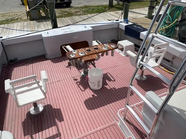 Slide: The Image of 2022 Custom Carolina Sportfish boat deck with fishing chairs and equipment. - 6