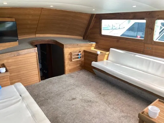 Slide: The Image of Luxurious interior of 2022 Custom Carolina Sportfish with wood paneling and white seating. - 9