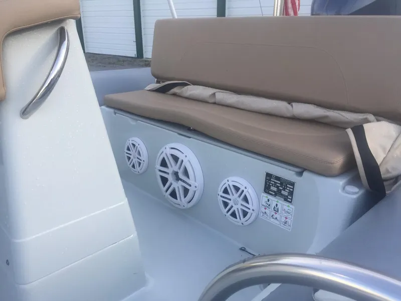 Slide: The Image of 2017 Zodiac Medline 580 boat interior with beige seating and built-in speakers. - 5