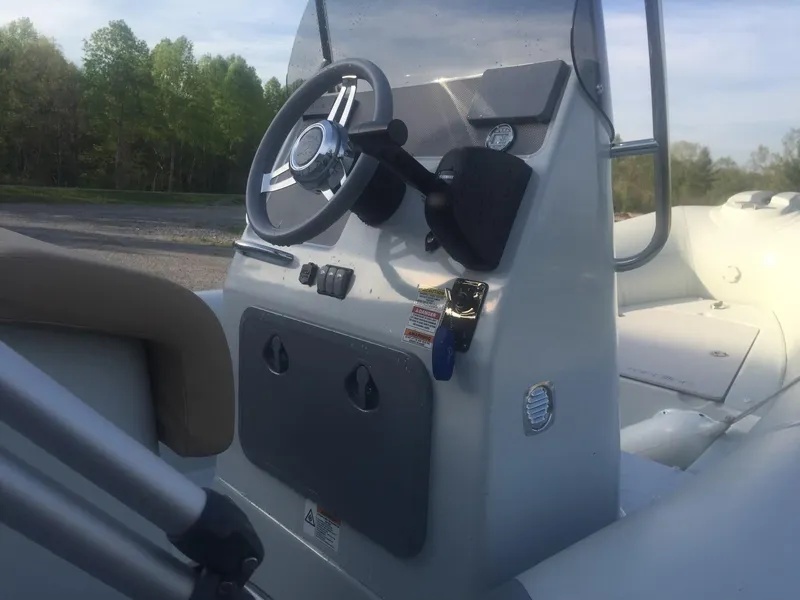 Slide: The Image of 2017 Zodiac Medline 580 boat console with steering wheel and controls. - 6