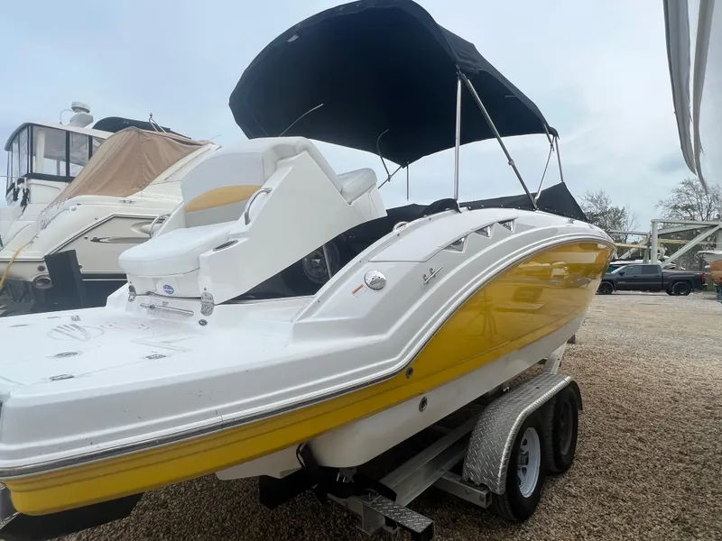 Slide: The Image of 2012 Chaparral 264 Sunesta boat with yellow hull on a trailer. - 4