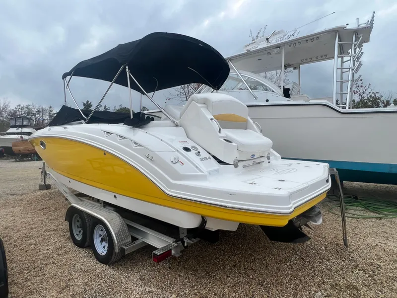 Slide: The Image of 2012 Chaparral 264 Sunesta boat with yellow hull on a trailer. - 5