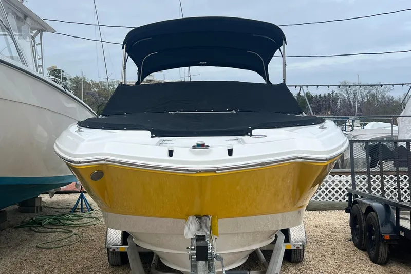 Slide: The Image of 2012 Chaparral 264 Sunesta boat with yellow hull on trailer. - 6