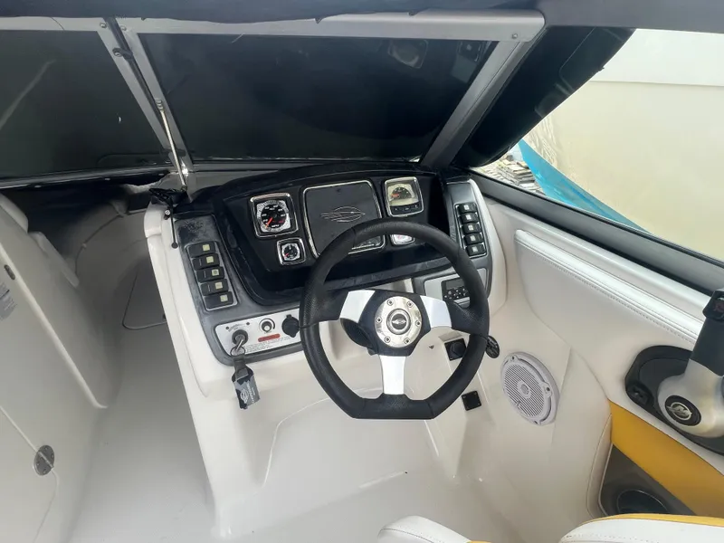 Slide: The Image of 2012 Chaparral 264 Sunesta boat cockpit with steering wheel and control panel. - 8