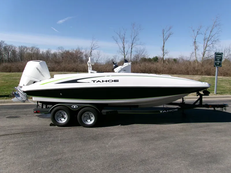 The Image of 2024 Tahoe 2150 CC boat on trailer, parked outdoors on a sunny day. - 0