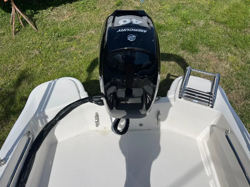 Slide: The Image of 2025 Boston Whaler 130 Super Sport boat with Mercury 40 engine, viewed from above. - 15