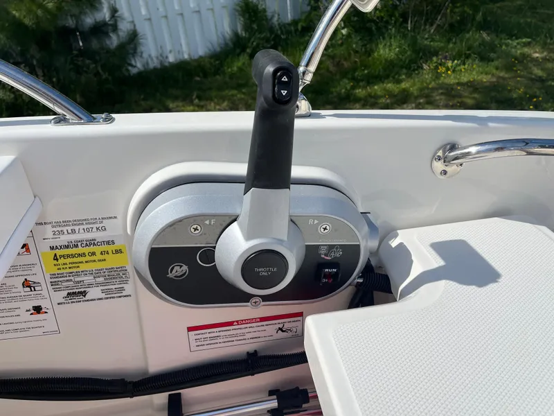 Slide: The Image of 2025 Boston Whaler 130 Super Sport throttle control, featuring ergonomic design and safety instructions. - 7