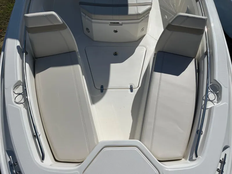 Slide: The Image of 2025 Boston Whaler 280 Dauntless boat interior with cushioned seating and storage compartments. - 11