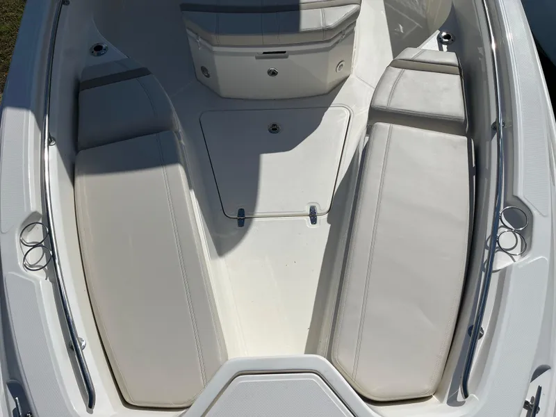 Slide: The Image of 2025 Boston Whaler 280 Dauntless boat interior with cushioned seating and storage compartments. - 12