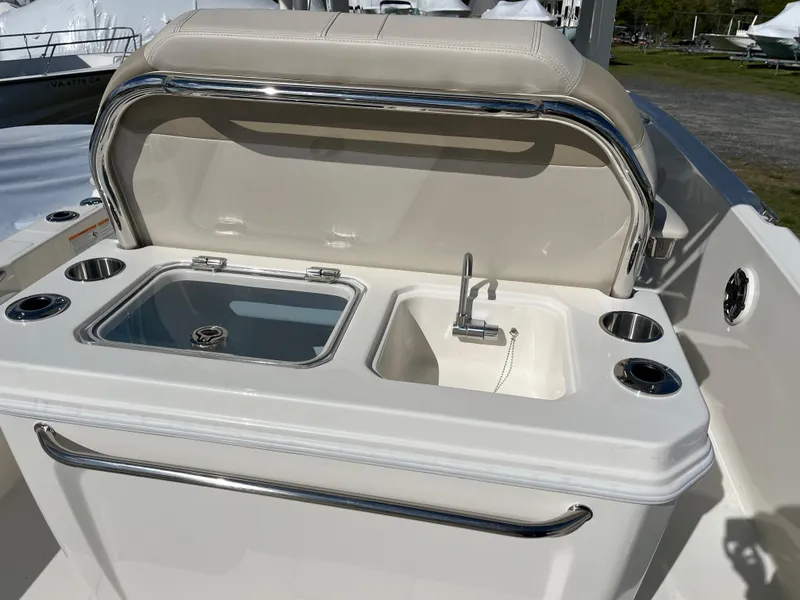 Slide: The Image of 2025 Boston Whaler 280 Dauntless boat with open storage compartment and sink. - 15