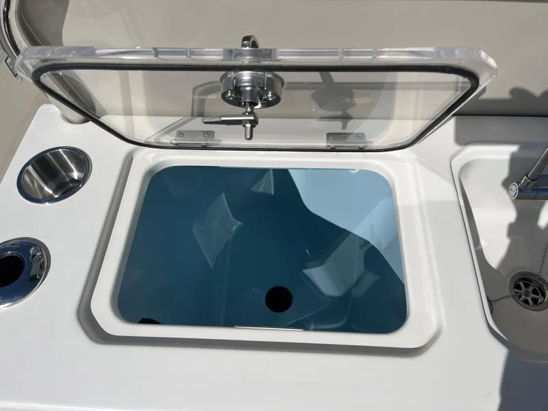 Slide: The Image of Livewell on 2025 Boston Whaler 280 Dauntless boat, featuring stainless steel cup holders. - 16