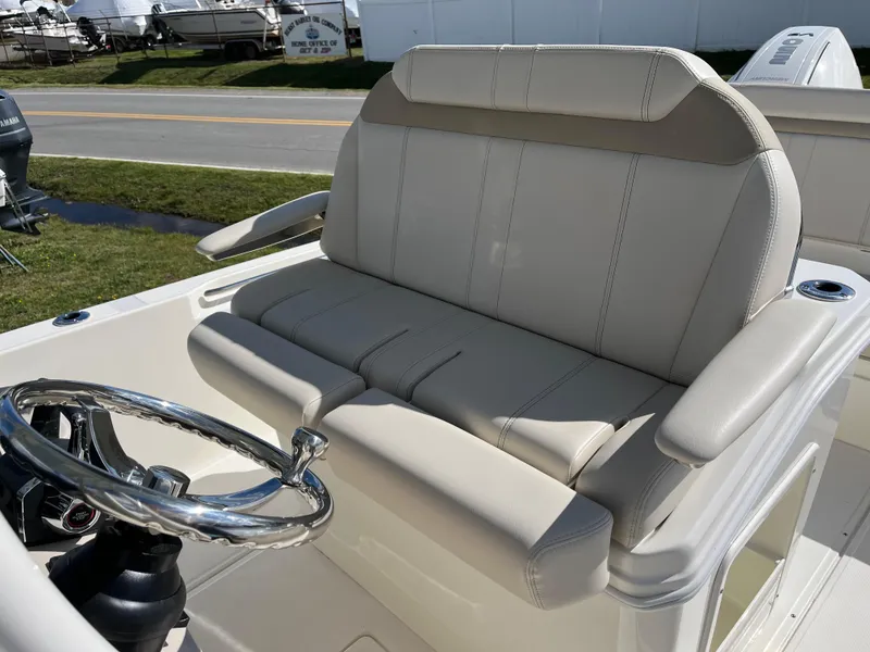 Slide: The Image of 2025 Boston Whaler 280 Dauntless boat helm with cushioned seating and steering wheel. - 17